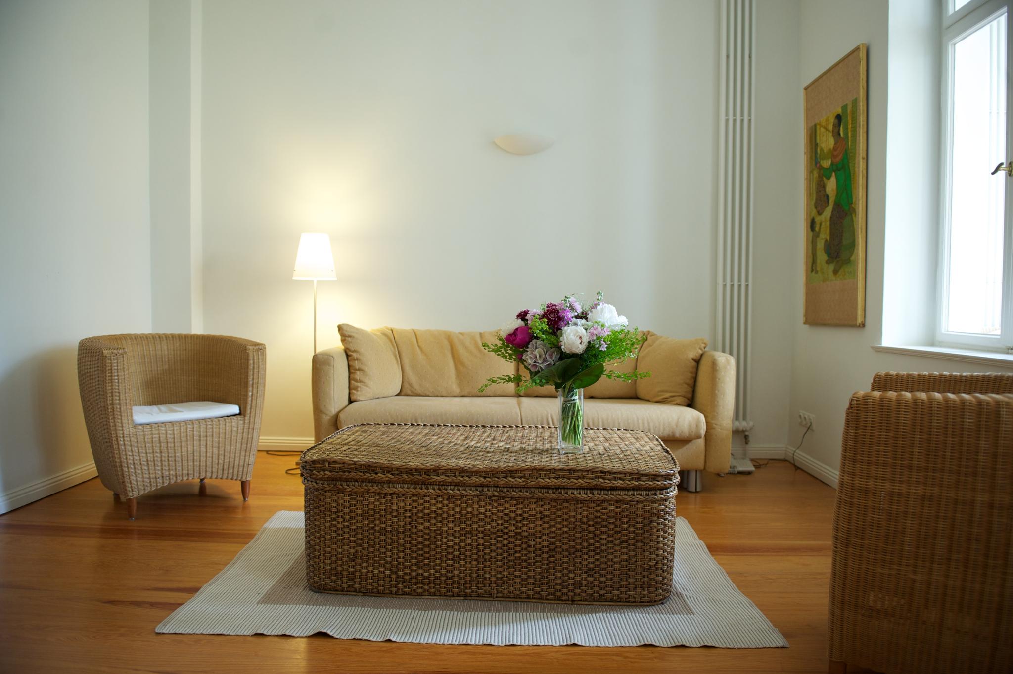 Wohnzimmer mit Holzfußboden und einer senfgelben Sitzecke