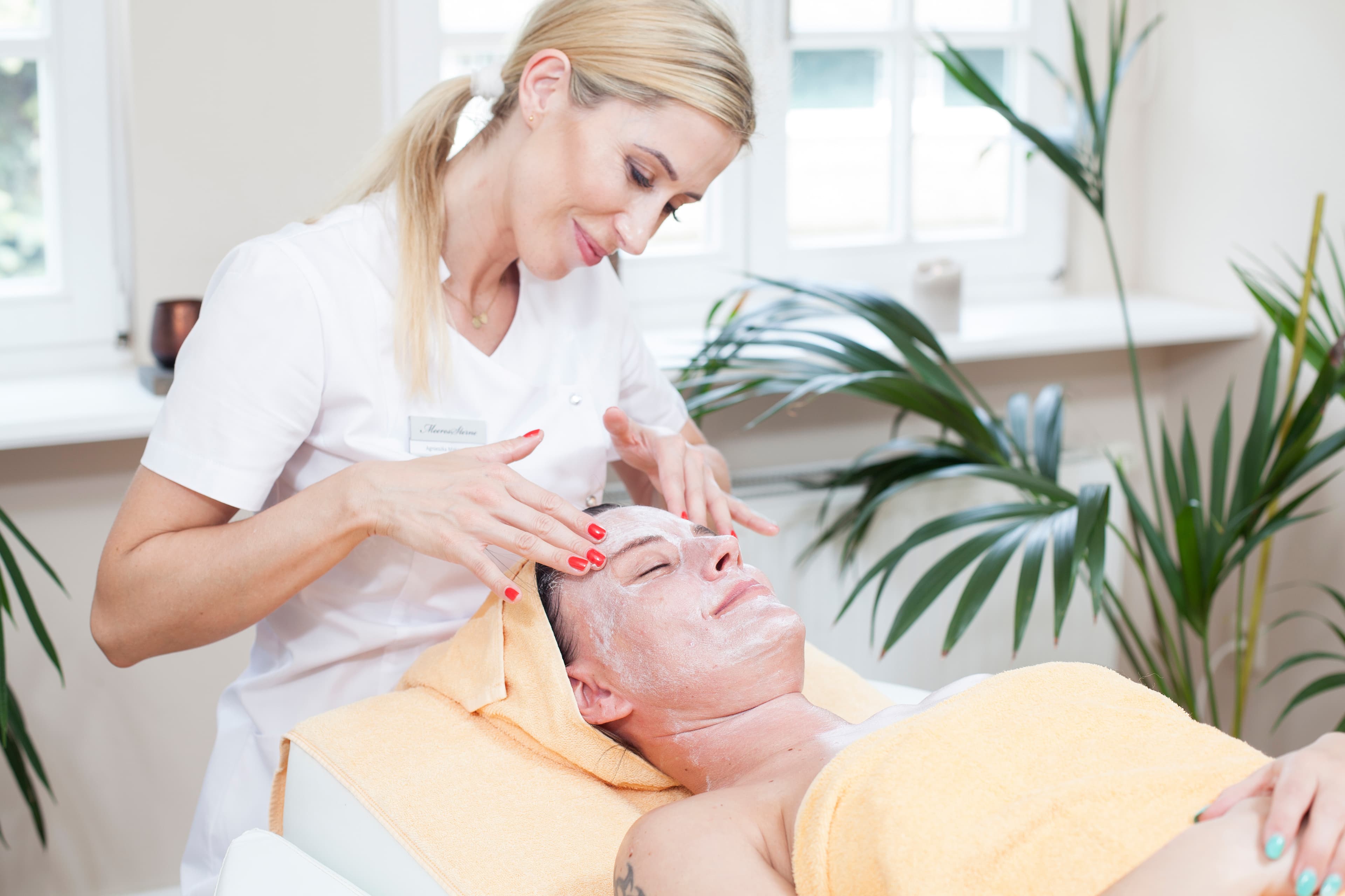 Frau erhält eine Gesichtsanwendung im Wellness-Bereich