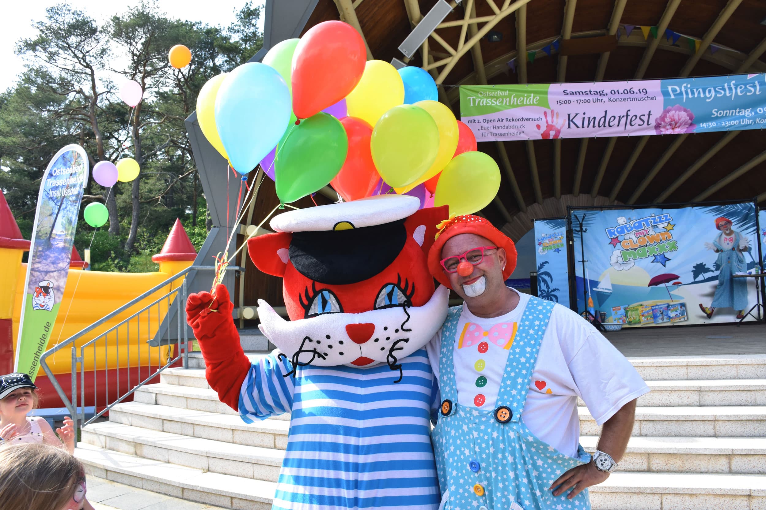 Maskottchen Fiete von Trassenheide mit einem Clown vor der Konzertmuschel