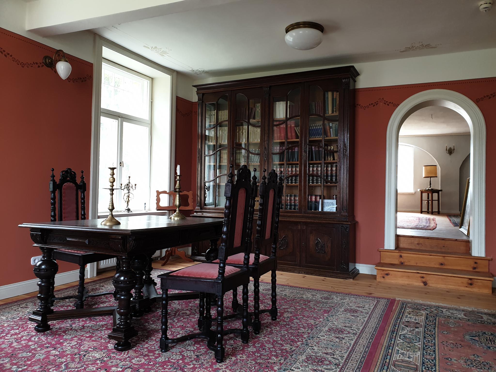 Ausstellungsraum mit Schreibtisch und Bücherschrank im Schloss Stolpe